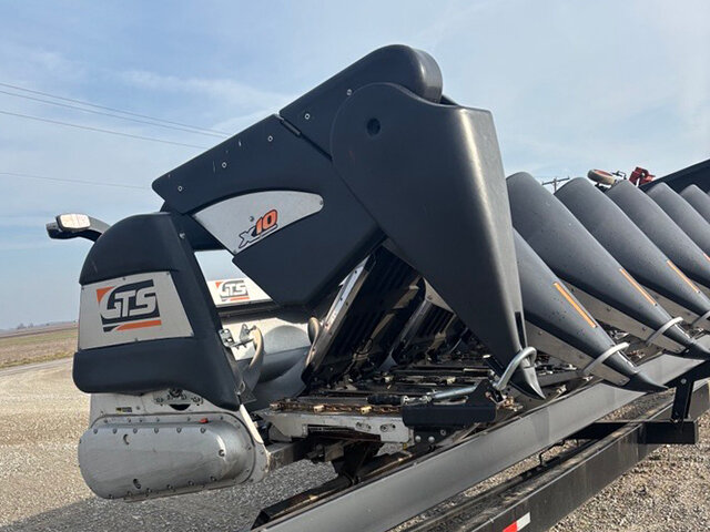 side view of the 20 23 G T S X 10 8 row corn head with an end divider folded up